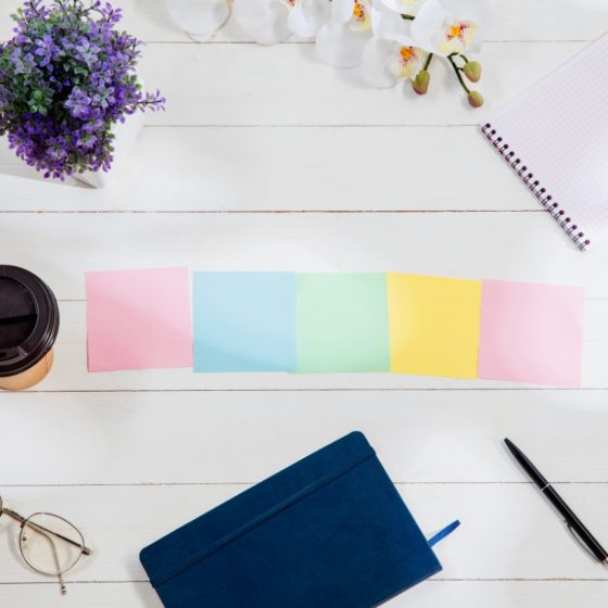 colorful sticky notes and journal on a desk